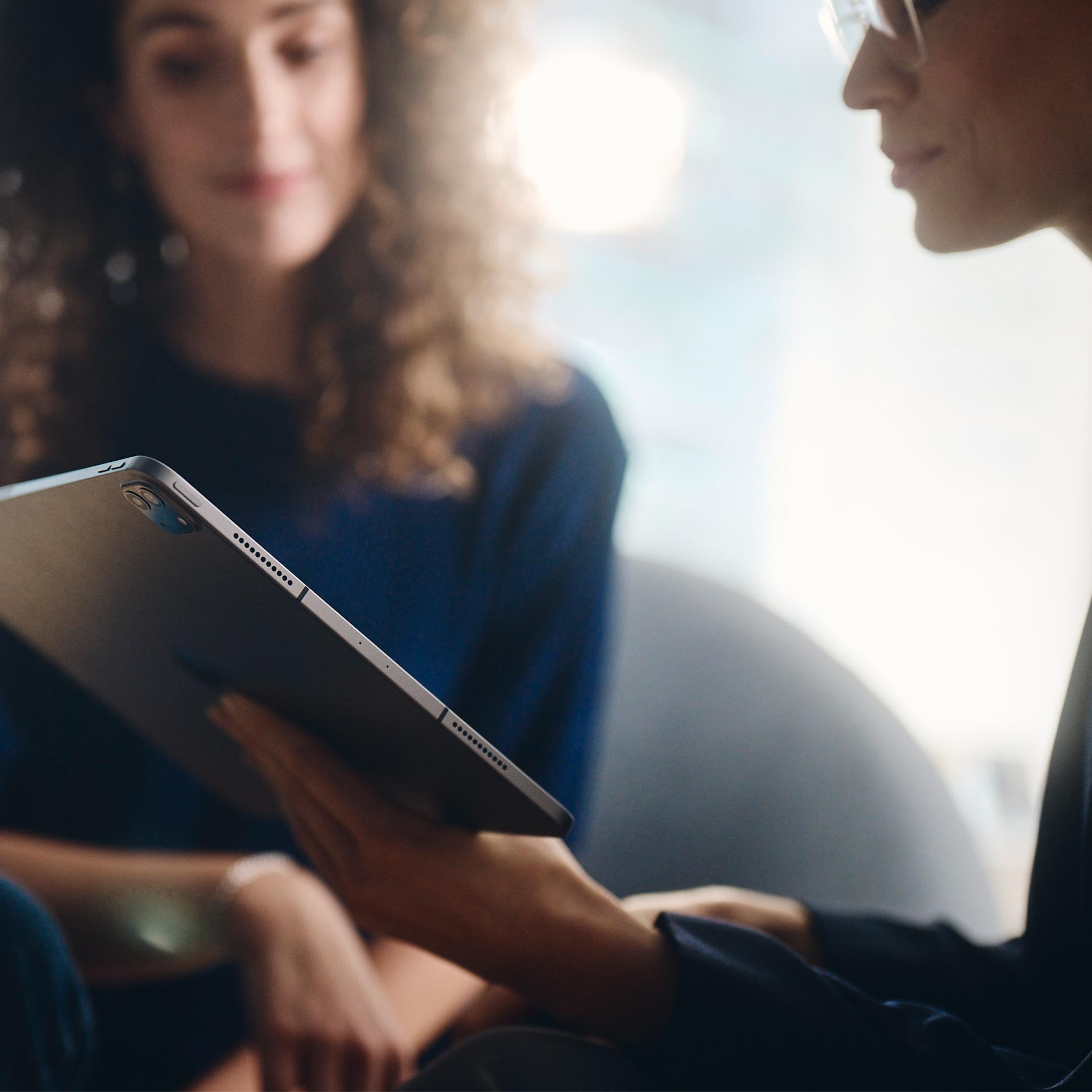 Two women looking at a tablet.