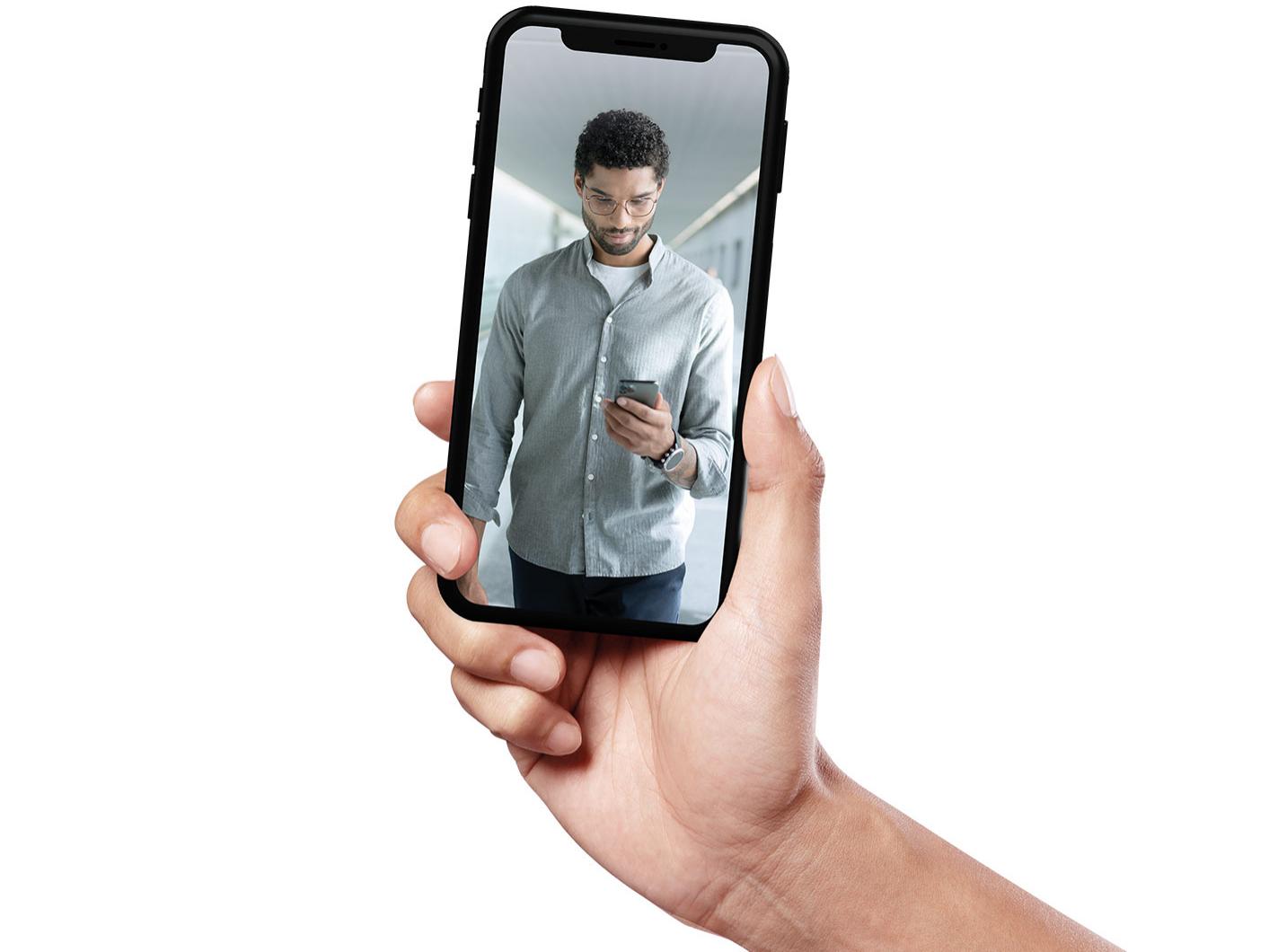 Smartphone showing a young man with short hair walking and wearing ZEISS SmartLife lenses.