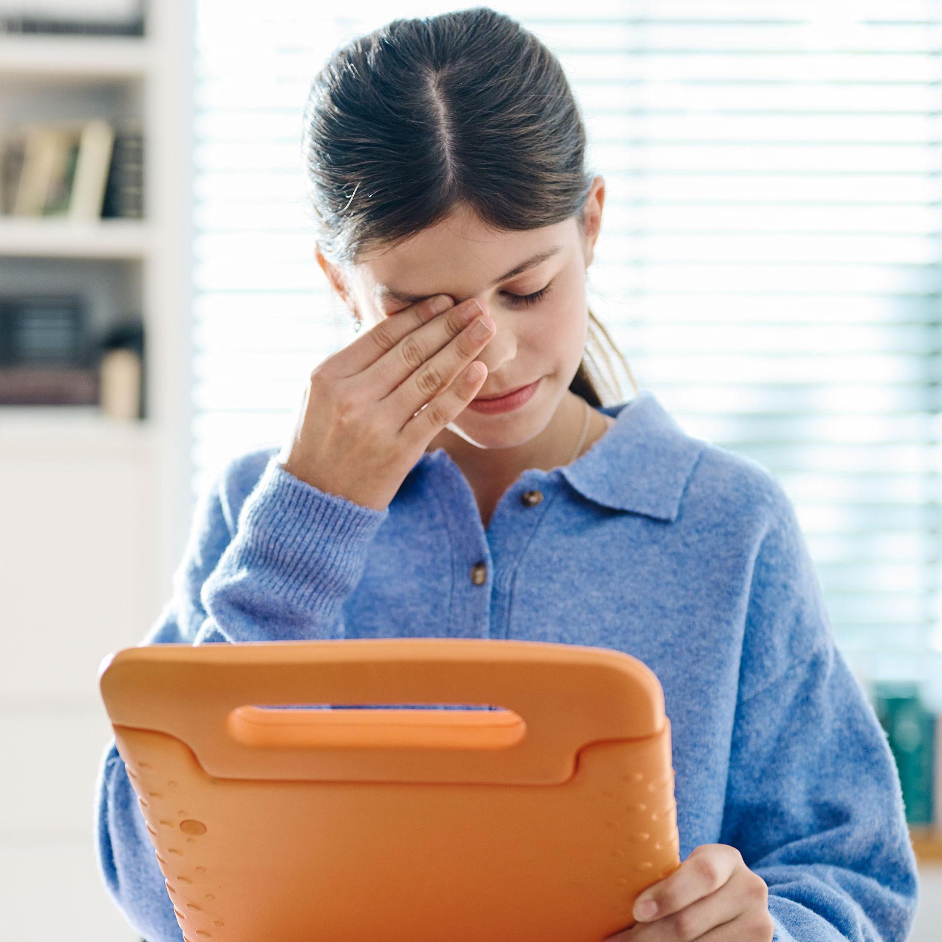 Girl with a tablet putting her hand on the face