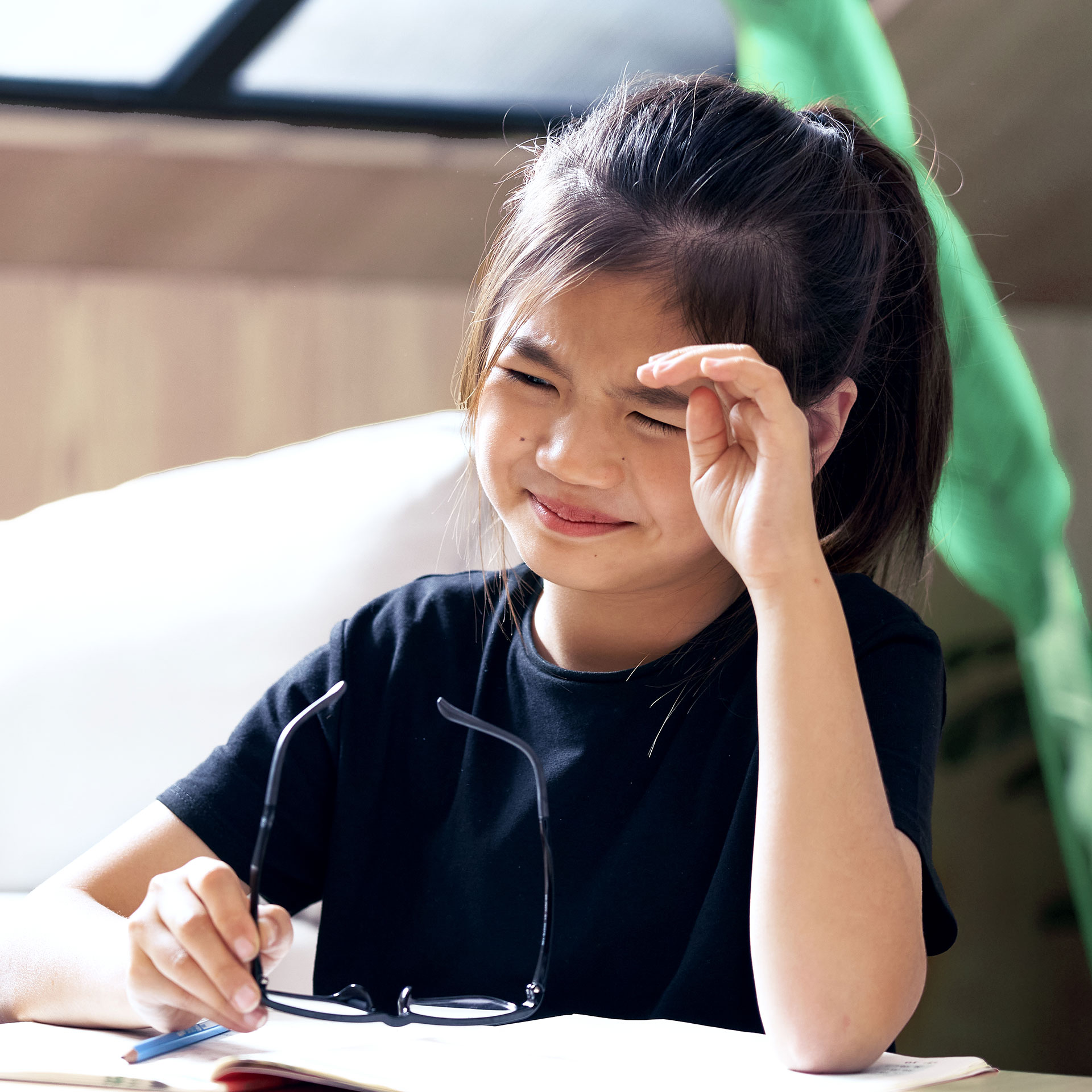 Young girl rubbing her eyes